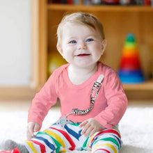 a woman sitting on a floor in a room